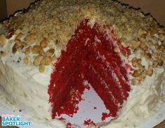 a red velvet cake with white frosting and nuts