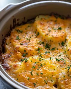 a casserole dish with potatoes and parsley