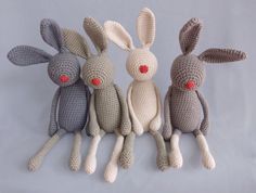 three crocheted rabbits sitting next to each other on a white background with the words it's deen written below them