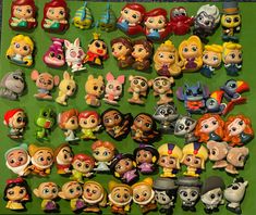 various toy figurines are displayed on a green surface