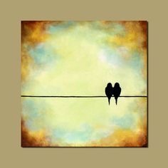 two birds are sitting on a wire and one is looking up at the sky with clouds