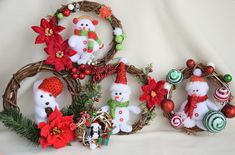 christmas ornaments are arranged in baskets on a white surface, including teddy bears and poinsettis