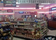 the inside of a grocery store filled with food and drink items, including sodas