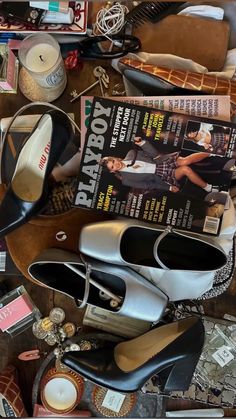 there is a pile of shoes and magazines on the table