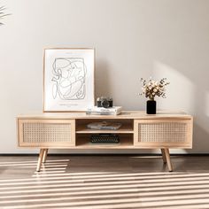 a living room with a tv stand and vases on the side table in front of it