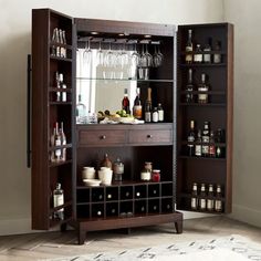 a wooden cabinet filled with lots of bottles and glasses