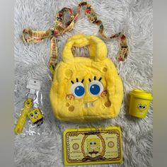 a yellow purse with blue eyes on it next to some other items and a package