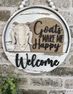 a sign that says goats make me happy welcome on the side of a brick wall