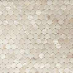 a close up view of a white tile wall with circles on the bottom and sides