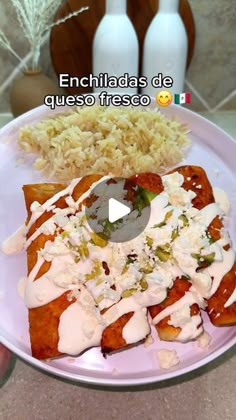 a white plate topped with food next to two vases filled with rice and sauce