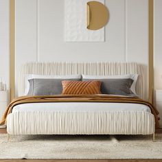 a white bed with two pillows on top of it