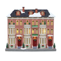 a red brick building with christmas wreaths and lights on it's front windows