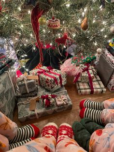 many wrapped presents under a christmas tree