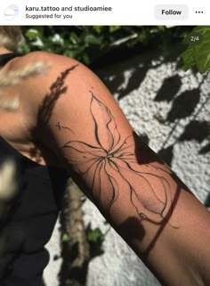 a woman's arm with a tattoo on it that has a flower in the middle