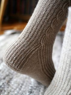 a person's feet with socks on top of them