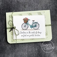 a handmade card with a bicycle and flowers on the front, saying something in the words of change