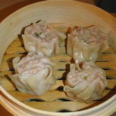 some dumplings are in a wooden bowl on a table