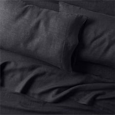 black linen sheets and pillowcases on top of each other