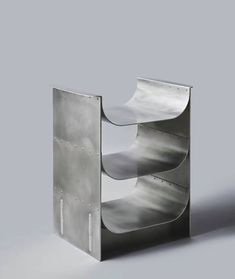 a metal shelf with three shelves on each side and two holes in the middle to hold items