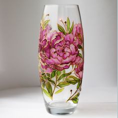 a glass vase with flowers painted on it