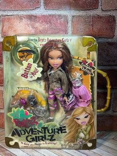 the doll is in its box and it has an advertisement for her adventure girlz