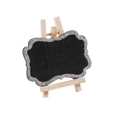 an easel with a blackboard on it and silver glitter trim around the edge