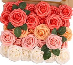 a box filled with lots of pink and orange roses