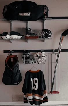 a hockey jersey hangs on the wall next to other sports equipment