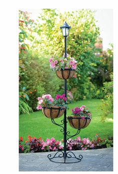 three tiered planter with flowers in it