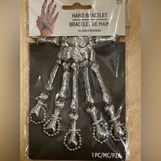 a package of hand and wrist bracelets in the shape of a human figure on display