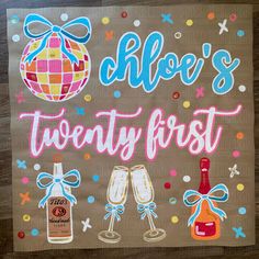 a sign that says cloe's twenty first with two champagne glasses and a bottle