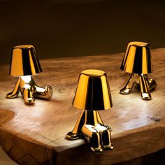 three lamps sitting on top of a wooden table next to each other with the words shop by products