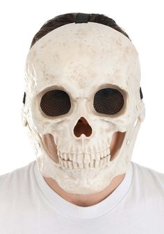 a man wearing a white skull mask with black eyes