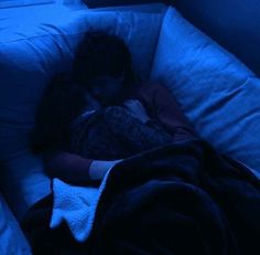 a woman is sleeping in her bed at night