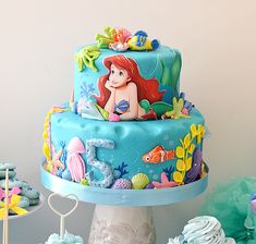 the little mermaid cake is decorated with fondant decorations