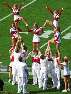 the cheerleaders are doing stunts on the field