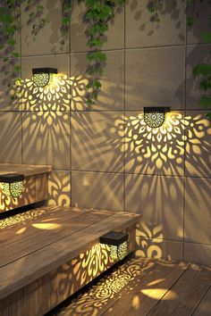 three wooden benches sitting next to each other on top of a wooden floor covered in shadows