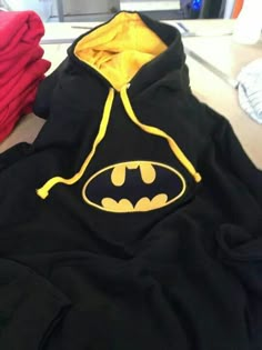 a batman hoodie is sitting on a table