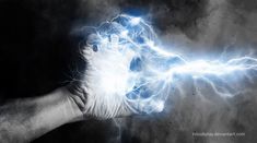 a hand holding a lightning bolt in the dark