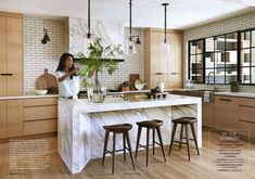 a kitchen with marble counter tops and wooden stools