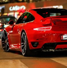 a red sports car parked on the street at night