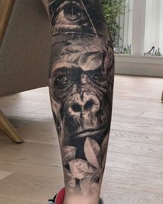 a man's leg with a tattoo on it and an image of a gorilla