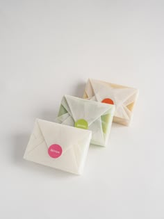 three small envelopes sitting next to each other