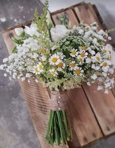 a bouquet of daisies and other flowers on a table