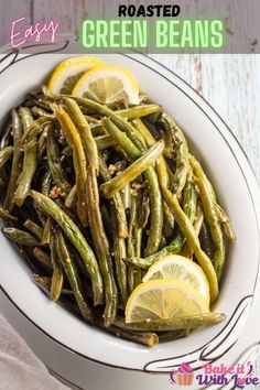 green beans in a white bowl with lemon wedges and seasoning on the side