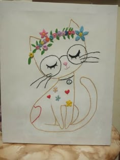 a white card with a cat and flower crown on it