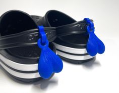 a pair of black and white shoes with blue handles