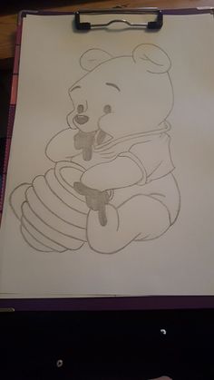 a drawing of a teddy bear holding a honeybee on a piece of white paper