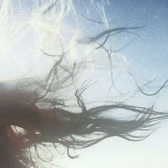 a woman with her hair blowing in the wind