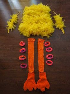 the costume is made up of yellow feathers and orange socks with red rings on them